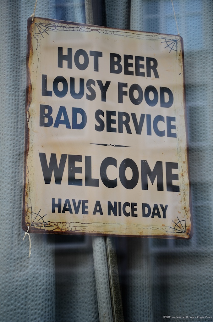 Hot_beer,_lousy_food,_bad_service_-_Welcome,_have_a_nice_day_sign_in_Antwerp,_Belgium.jpg